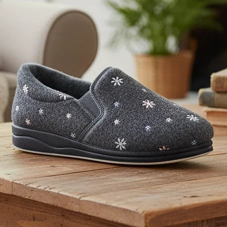 Grey low-profile slippers with white flower/star embroidery and molded rubber sole