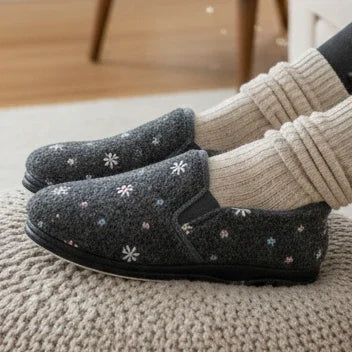 Grey slip-on slippers with white flower/star pattern and textured side panel
