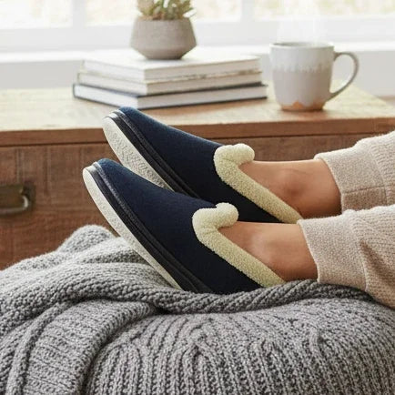 Navy plush slip-on slippers with light tan paw appliqué and textured rubber sole