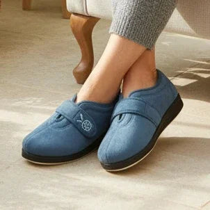 Women’s blue denim slippers worn with gray pants