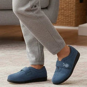 Women’s blue denim slippers worn with cuffed gray pants