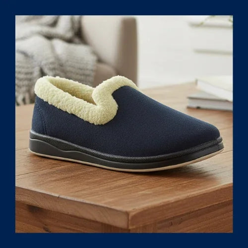 Navy plush slip-on slipper with light tan paw appliqué and grippy dark sole