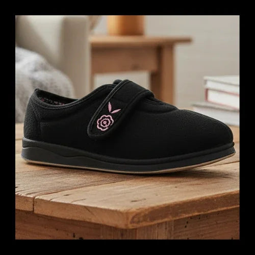 Black women’s slippers with pink floral embroidery and front strap detail